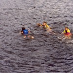 kids swimming off of island